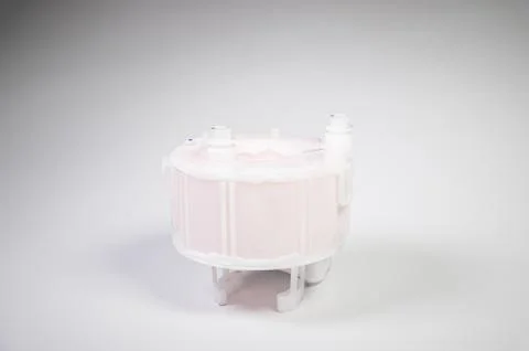 New spare part. Replaceable white plastic inner fuel filter on a gray gradient 스톡 사진