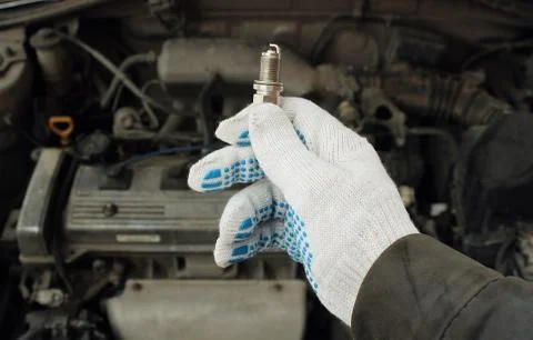 A new spark plug in hand Stock Photos
