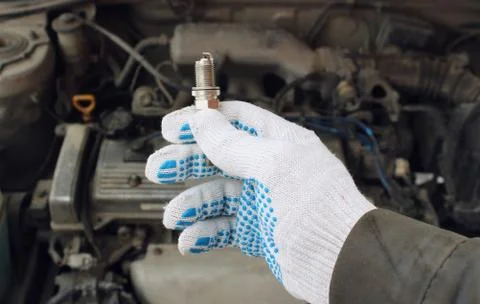 A new spark plug in hand Stock Photos