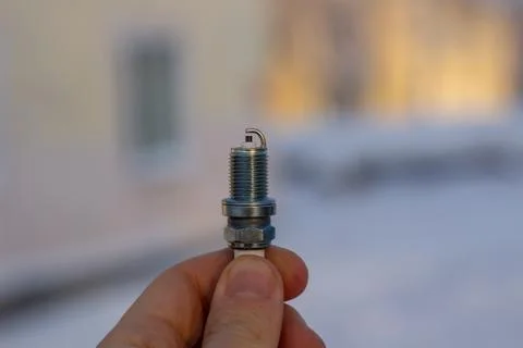 New spark plug in hand. Replacing spark plugs in the car. 스톡 사진