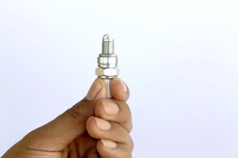 New spark plug in hand before use. Stock Photos