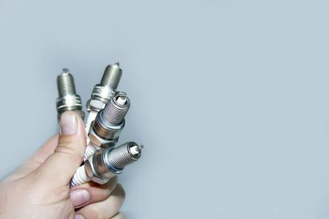New spark plug in hand before use. Stock Photos