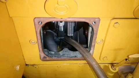 The new standby generator engine oil is inserted using a hose. Stock Footage 98535211