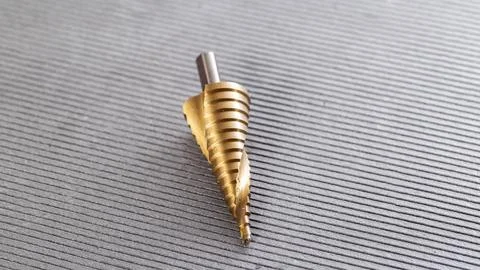 New step drill on gray background. Concept of tool for screwdriver, close-up Foto stock