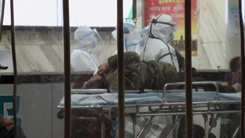 New strains of Delta and Lambda coronavirus. Medics in protective suits (1) Stock Footage 156869176