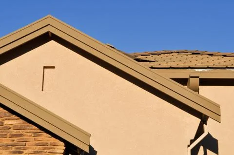 New stucco home under construction with blue sky Stock Photos