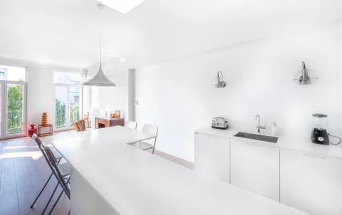 New stylish bright kitchen with white cabinets. Spacious modern interior with Stock Photos