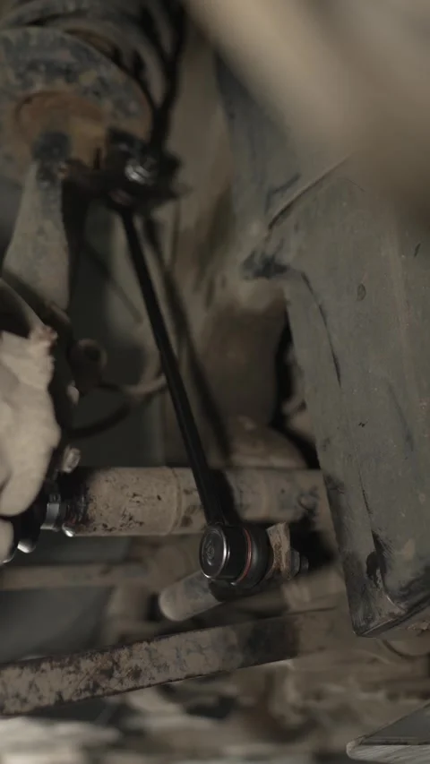 A new sway bar link is mounted on a car suspension. Stock Footage 341331520