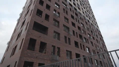 New tall building with numerous windows and dark facade Stockbeeldmateriaal 304412291