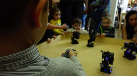 New technologies. Robot.  AI.  Children playing with robots. Stock Footage 50226063