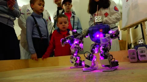 New technologies. Robot.  AI. Children watching the dancing robots. Stock Footage 50227023