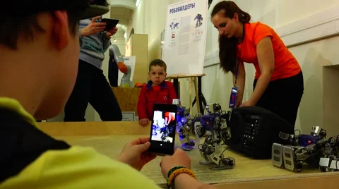 New technologies. Robot.  AI. Children watching the dancing robots. Stock Footage 50227518