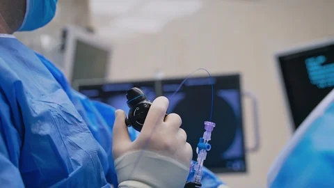 New technologies in surgery. Close-up doctor's hand with modern equipment during Stock Footage 122072523