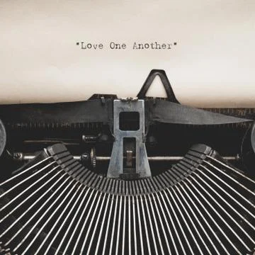 New Testament Scripture quote Love One Another by vintage typewriter Stock Photos