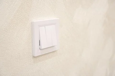 New three-key light switch on the wall Stock Photos