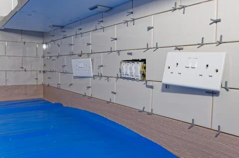 New tile installation in kitchen with electrical sockets removed Stock Photos