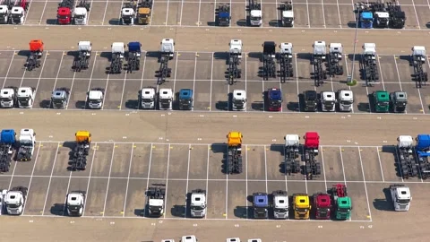 New trucks parked in rows at a manufacturing plant parking lot Stock Footage 341875217