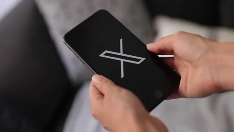 New twitter logo on the screen of mobile phone. Social media news Stock Footage 247015899