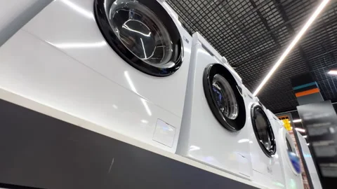 New washing machines stand in rows in an appliance store. Extreme wide low angle Stock Footage 246718691