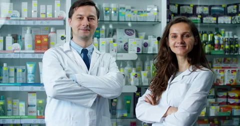 New way of greeting to avoid the spread of coronavirus. Two pharmacist friends Stock Footage 133731252