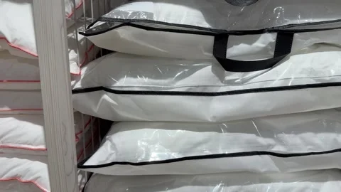 New white pillows stacked on store shelves Stock Footage 331464689