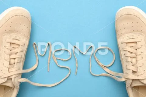 New women sneakers with laces in memo text. Stock Photos
