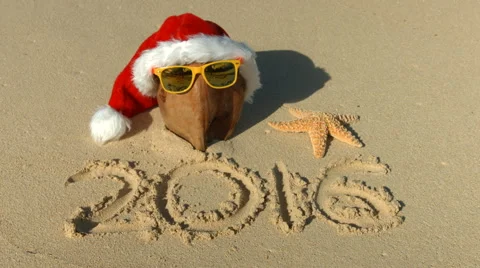 New Year 2016 - Santa hat for Christmas And Coconut On Tropical Hawaii Beach Stock Footage 57726033