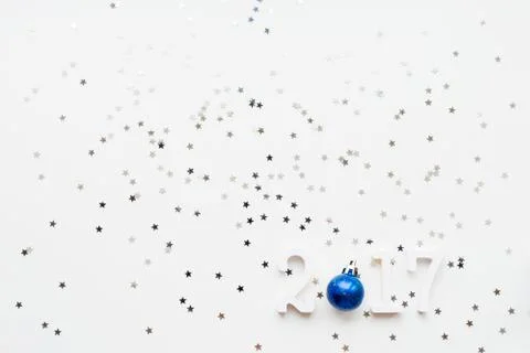 New Year 2017 background with bright blue ball and stars confettil Stock Photos