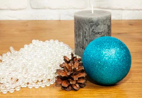 New Year 2017 composition with beads, fir cones and candle on wooden backgrou Stock Photos