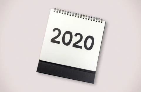 New year 2020 concept: flat lay of desktop calendar on grey background Stock Photos