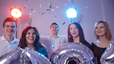 New year 2021 concept. Group of cheerful young people holding number balloons Stock Footage 100347401