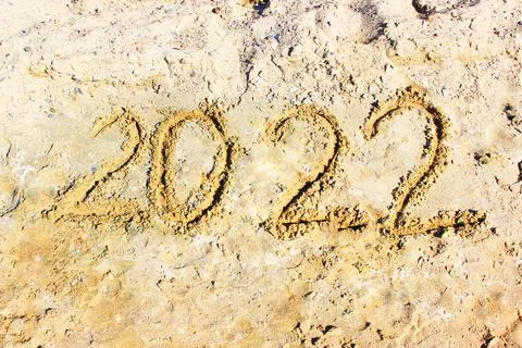 New Year 2022. Message written on the background of a sandy beach. hello concept Stock Photos