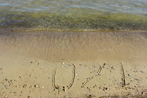 New Year 2022. Message written on the background of a sandy beach. hello concept Stock Photos