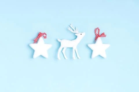 New Year and Christmas composition from white stars, deer on pastel blue back Stock Photos