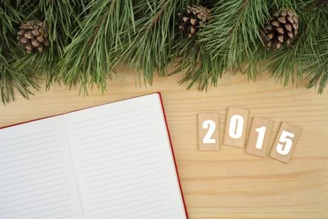 New Year background. Notebook on table with Christmas fir tree and wooden tablet Stock Photos