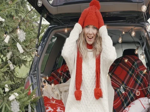 New Year. Beautiful girl in the trunk of her car is happy smiling Stock Footage