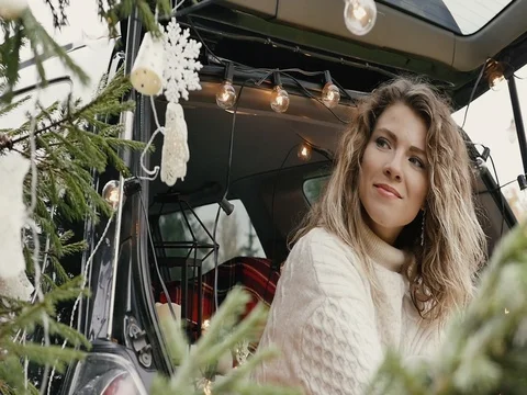 New Year. Beautiful girl in the trunk of her car is happy smiling Stock Footage