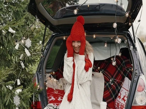 New Year. Beautiful girl in the trunk of her car is happy smiling Stock Footage