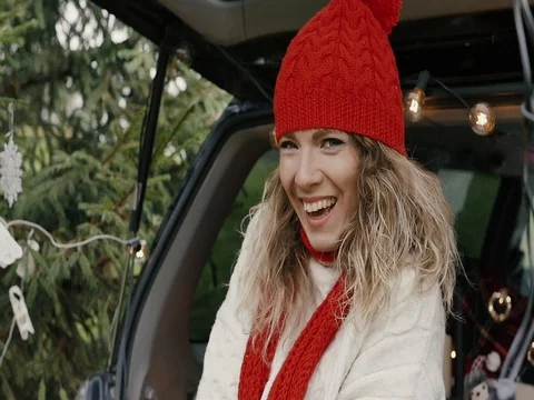 New Year. Beautiful girl in the trunk of her car is happy smiling Stock Footage