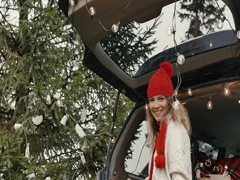 New Year. Beautiful girl in the trunk of her car is happy smiling Stock Footage