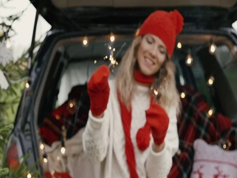 New Year. A beautiful girl in the trunk of her car with Bengal lights is happy Stock Footage