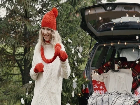New Year. Beautiful girl in the trunk of her car is happy smiling Stock Footage