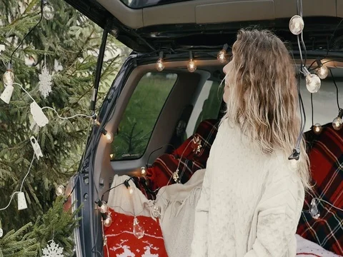 New Year. Beautiful girl in the trunk of her car is happy smiling Stock Footage