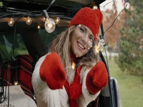 New Year. A beautiful girl in the trunk of her car with Bengal lights is happy Stock Footage
