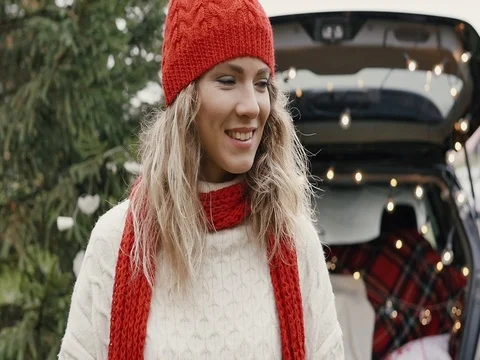 New Year. Beautiful girl in the trunk of her car is happy smiling Stock Footage