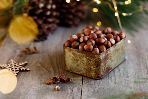 New year composition background with hazelnuts in box and bokeh, christmas mo Stock Photos