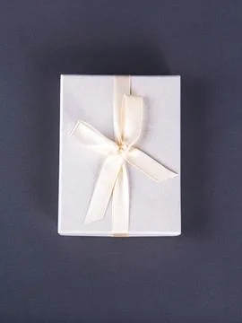 The new year composition of the packed present on the grey background. Stock Photos