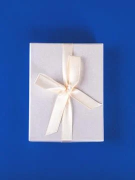 The new year composition of the packed present on the blue background. Stock Photos