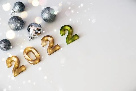 New Year composition silver balls toys and golden numbers 2022 on a white sno Stock Photos
