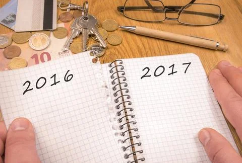 New year concept for 2017 A man s hands tears a page from a notebook with ... Stock Photos